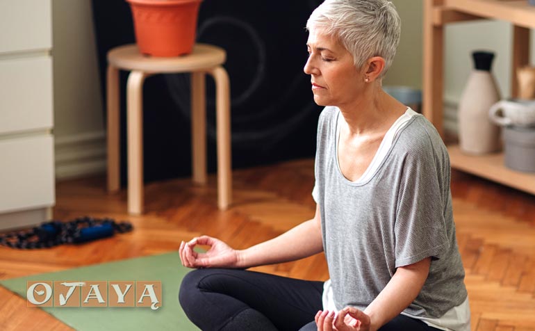 Middle-age woman practicing Ojaya mantra mindfulness