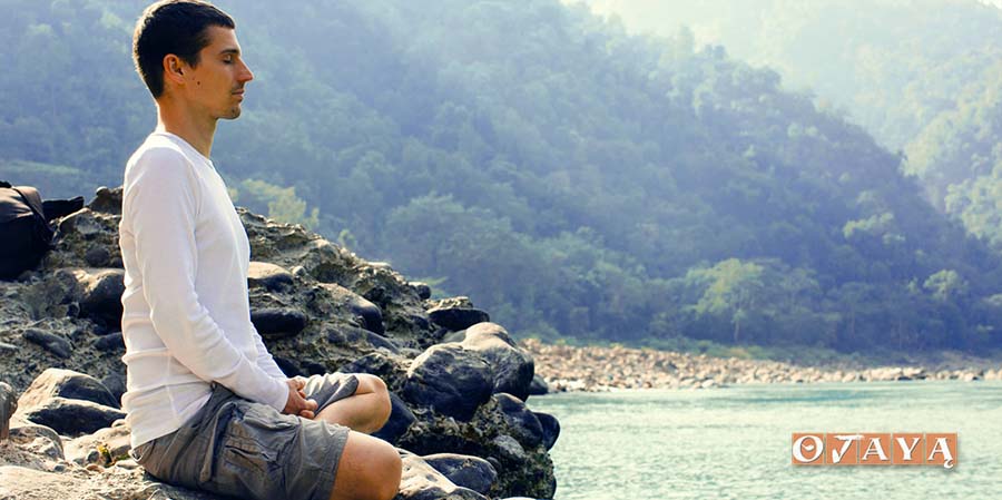 Young Man Meditating by River Ganga